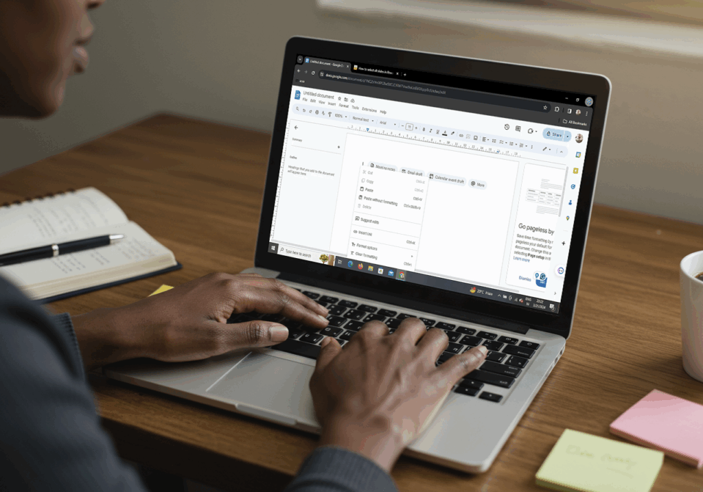 Team of professionals in a meeting room discussing project data on laptops and charts, demonstrating effective teamwork through modern collaboration tools and data sharing platforms.
