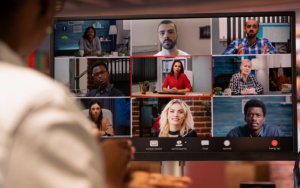 Students from different countries attending a live online class; grid-style video call with diverse participants; shared digital platform visible; represents technology enabling transnational education